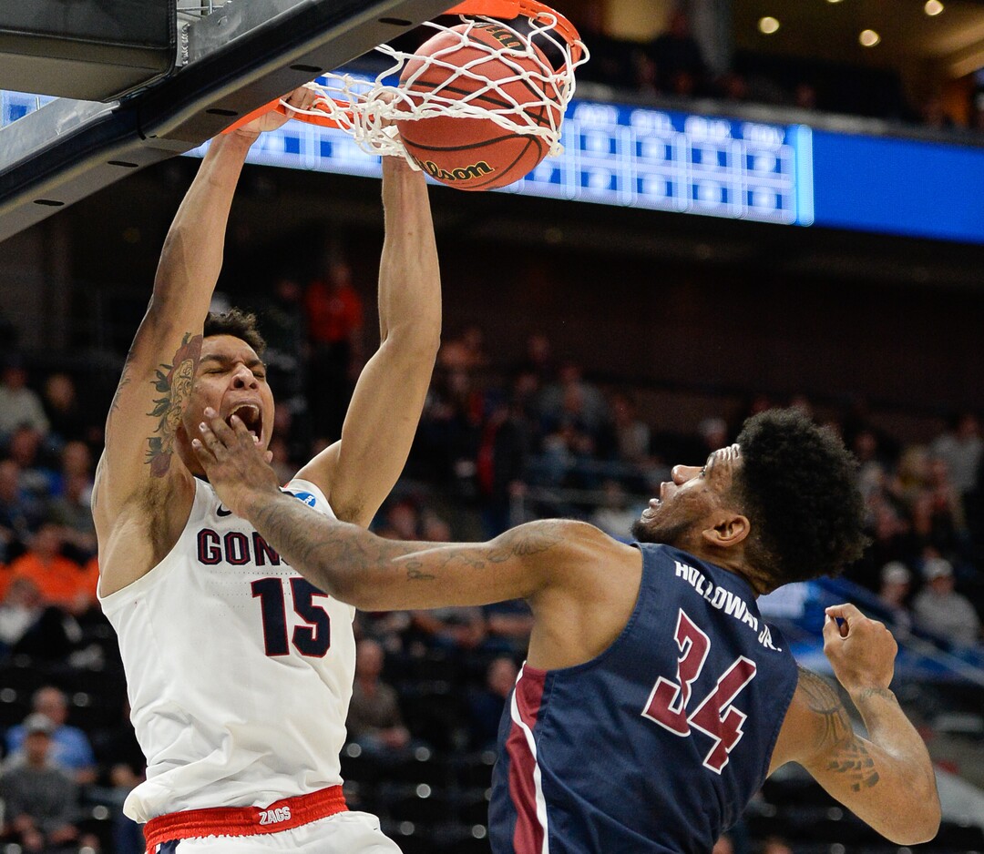 (Francisco Kjolseth  |  The Salt Lake Tribune)  Gonzaga Bulldogs forward Brandon Clarke (15) dunks over Fairleigh Dickinson Knights forward Mike Holloway Jr. (34) as Gonzaga faces Fairleigh Dickinson in their first round menÕs NCAA March Madness tournament game at Vivint Smart Home Arena in Salt Lake City on Thursday, March 21, 2019.