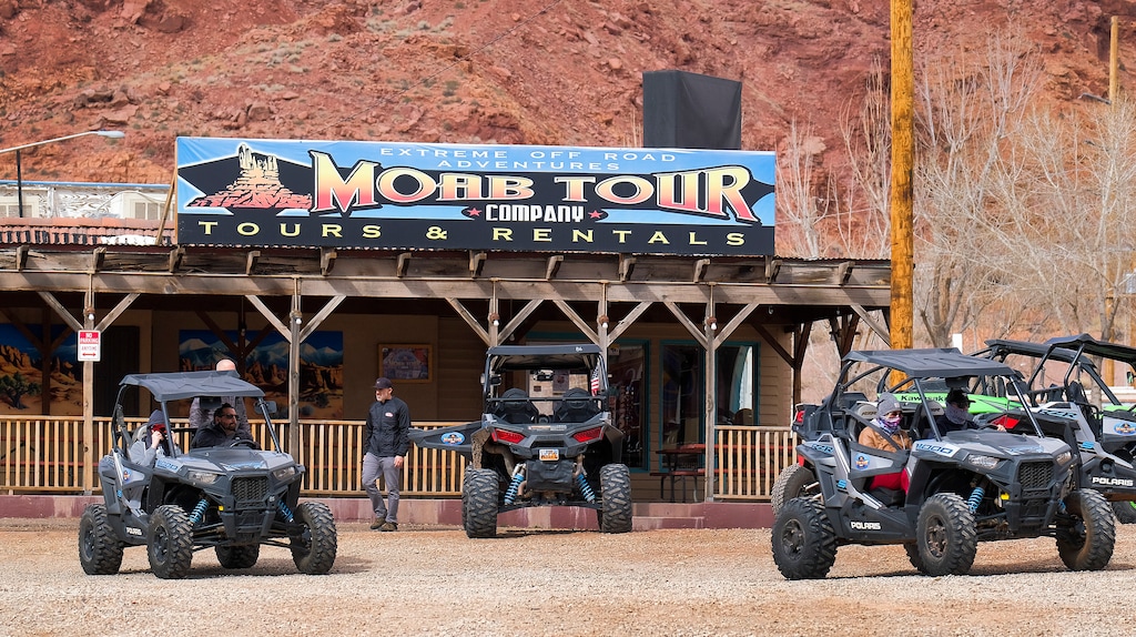 (Leah Hogsten | The Salt Lake Tribune) Thrill seekers driving off-road utility terrain vehicles (UTVs) rented from Moab Tour Company head out of the parking lot on Main Street to head towards the Sand Flats Recreation Area trail, located just 4 miles outside of town, Feb. 19, 2021. 