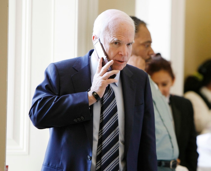FILE - In this Nov. 18, 2008, file photo, Sen. John McCain, R-Ariz., talks on the phone outside a Republican Caucus on Capitol Hill in Washington. (AP Photo/Gerald Herbert, File)