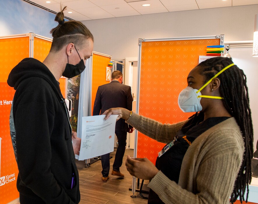 (Rick Egan | The Salt Lake Tribune)  Kezala Jokiel gets his Covid-19 test results from medical assistant Lolanna Eiland, at XpresCheck, which opened today for passengers at the Salt Lake City International Airport on Wednesday, Jan. 20, 2021.