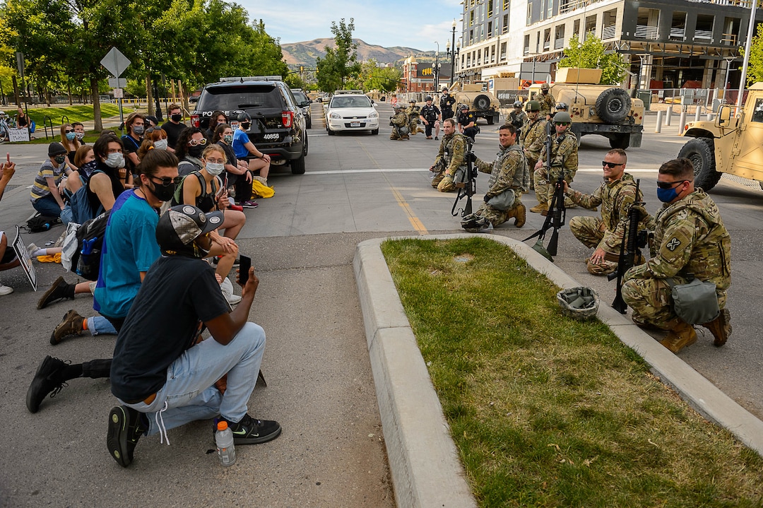 (Trent Nelson  |  The Salt Lake Tribune) A small group of Black Lives Matter activists led by Victoria Crosby kneel with National Guard and Salt Lake Police in front of the Public Safety Building in Salt Lake City on Tuesday, June 2, 2020.