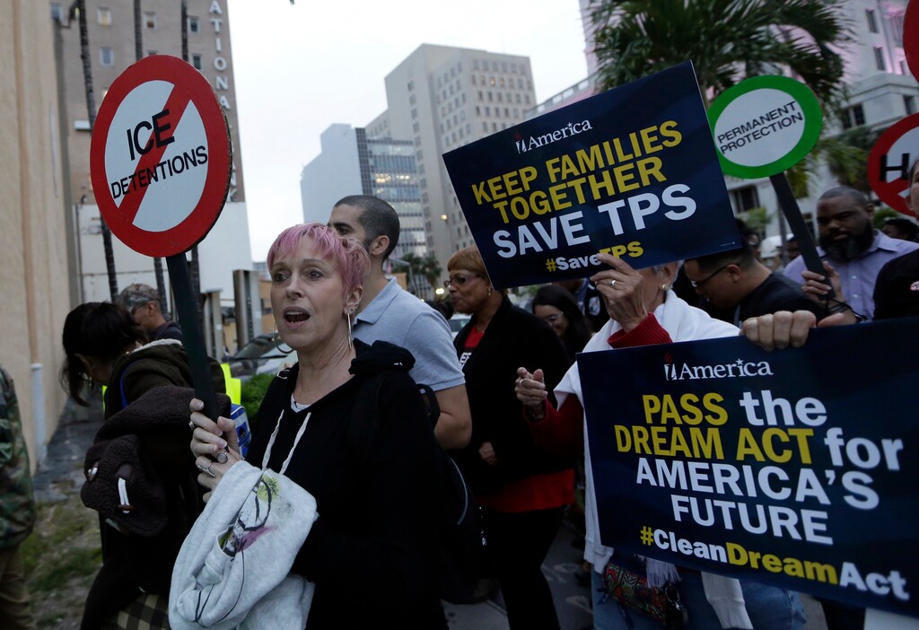 Mercedes Kent, of New York City, left, marches in support of Deferred Action for Childhood Arrivals (DACA) and Temporary Protected Status (TPS) programs for immigrants, Wednesday, Jan. 17, 2018, in Miami. (AP Photo/Lynne Sladky)