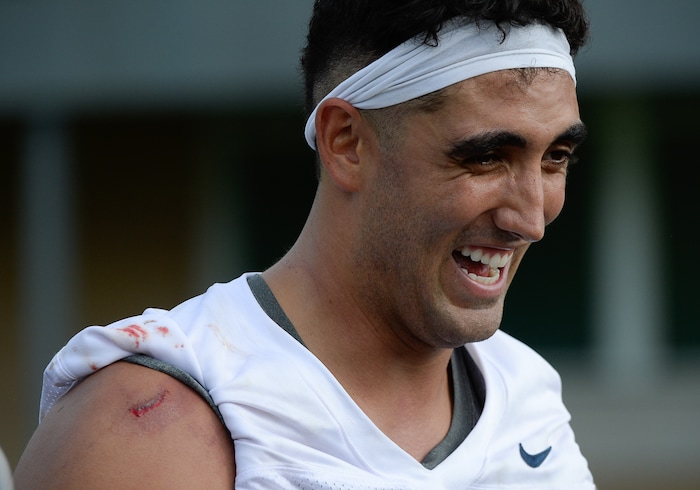 (Francisco Kjolseth  |  The Salt Lake Tribune)  BYU defensive lineman Corbin Kaufusi, sporting a bloodied shoulder, speaks with the media following preseason training camp on their practice field on Thursday, Aug. 2, 2018.