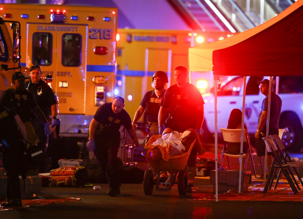 A wounded person is walked in on a wheelbarrow as Las Vegas police respond during an active shooter situation on the Las Vegas Stirp in Las Vegas Sunday, Oct. 1, 2017. Multiple victims were being transported to hospitals after a shooting late Sunday at a music festival on the Las Vegas Strip. (Chase Stevens/Las Vegas Review-Journal via AP)