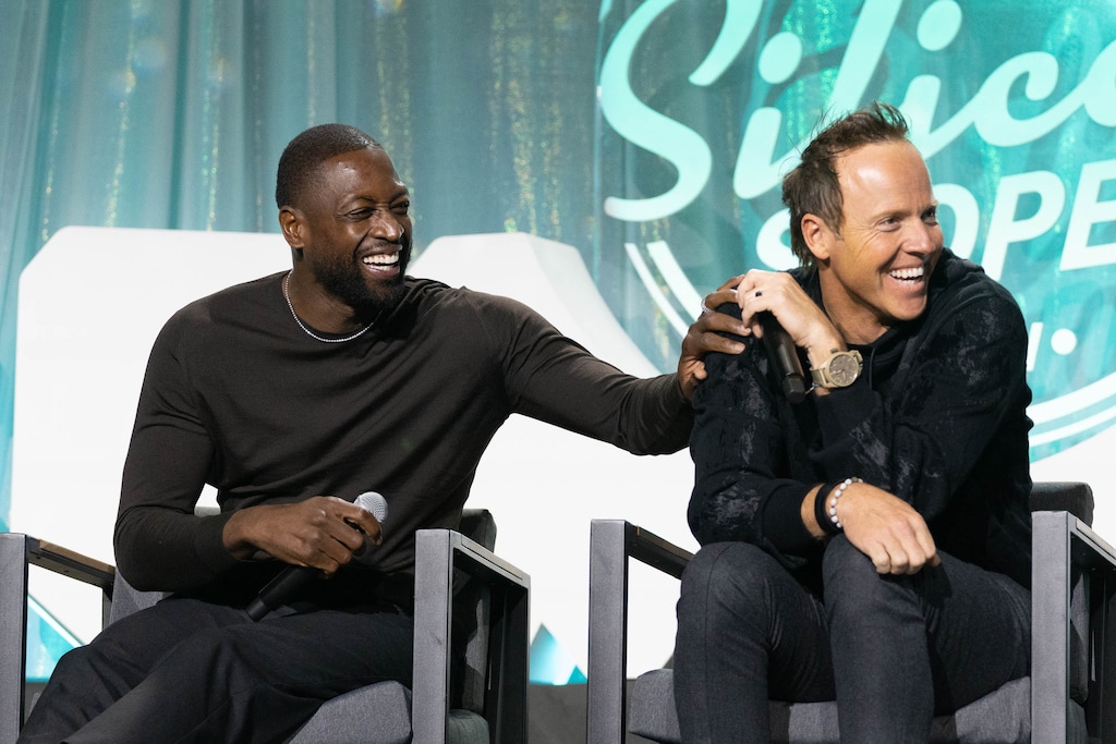 (Francisco Kjolseth | The Salt Lake Tribune) Dwyane Wade,  three-time NBA champion and part owner of the Utah Jazz   joins Ryan Smith, Founder and Executive Chairman of Qualtrics and owner of the Utah Jazz as they joke around on stage during the Silicon Slopes Tech Summit in Salt Lake City on Wednesday, Oct. 13, 2021.