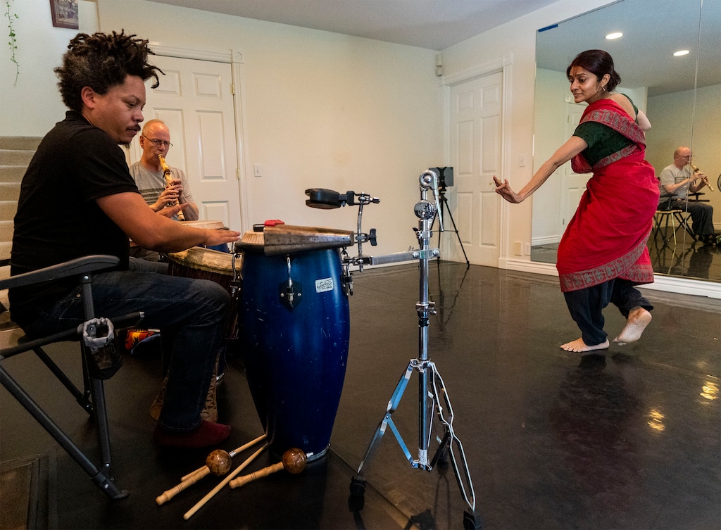 (Rick Egan | The Salt Lake Tribune)  Jyothsna Sainath dances as Wachira Waigwa-Stone plays the drums, and Gary Hansen plays a flute, as they rehearse on Friday, Aug. 26, 2022, for the Nitya Nritya Festival, a celebration of Indian dance and music, set for Sept. 10-11, 2022, at the Rose Wagner Performing Arts Center in Salt Lake City.