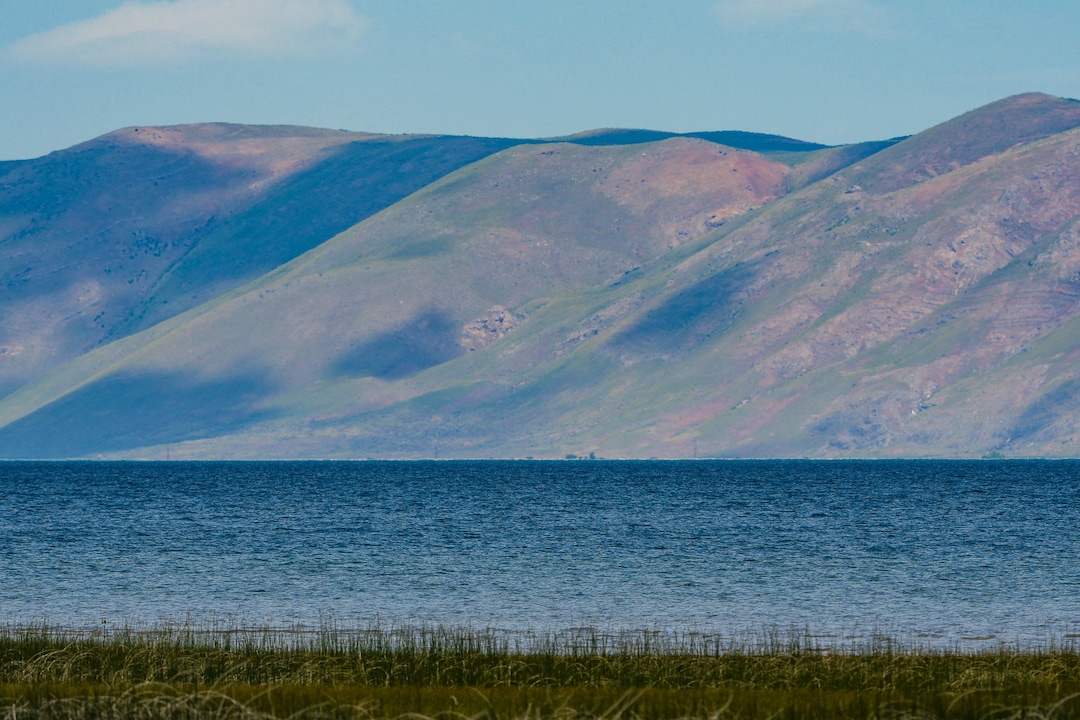 (Francisco Kjolseth | The Salt Lake Tribune) Sun spots dance between clouds on the eastern slopes of Bear Lake on Thursday, June 30, 2022. A new study is out showing the economic contributions of Bear Lake, underscoring the need to keep the lake healthy.