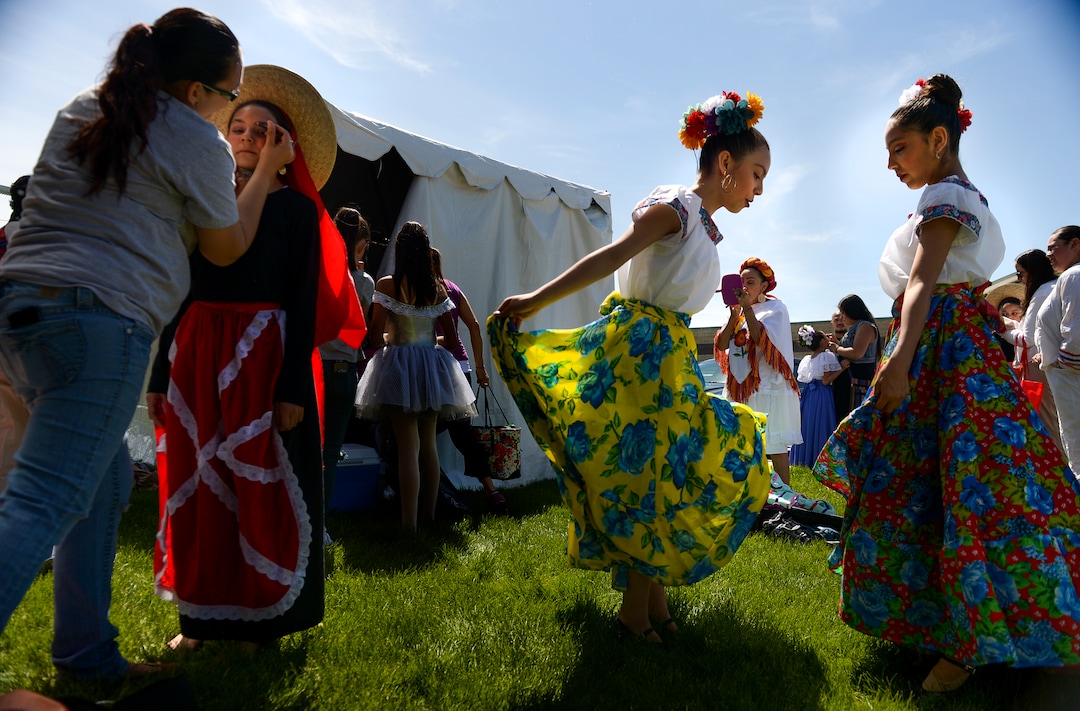 (Leah Hogsten  |  The Salt Lake Tribune) l-r Tuttilli Ballet Folklorico dancers Abish Judd applies makeup on her daughter Kali Judd, 10, while Mayleen Murillo, 14, and Stephanie Robles, 12, practice their dancing at the Cinco de Mayo Celebration, Saturday, May 5, 2018 at Centennial Park in West Valley City.