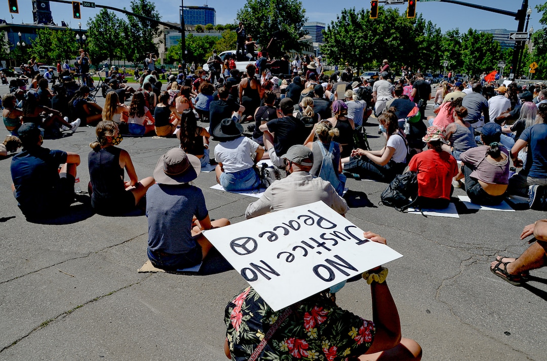 (Francisco Kjolseth  |  The Salt Lake Tribune) Demonstrators stop to protest outside the Salt Lake City Public Safety Building as part of a series of Juneteenth celebrations on Friday, June 19, 2020.