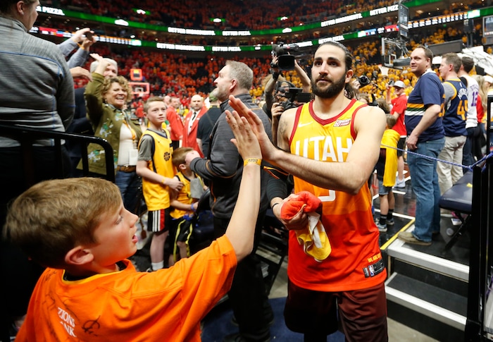 Utah Jazz guard Ricky Rubio (3) receives a high-five from a fan as he leaves the court following the team's 115-102 win over the Oklahoma City Thunder in Game 3 of an NBA basketball first-round playoff series Saturday, April 21, 2018, in Salt Lake City. (AP Photo/Rick Bowmer)