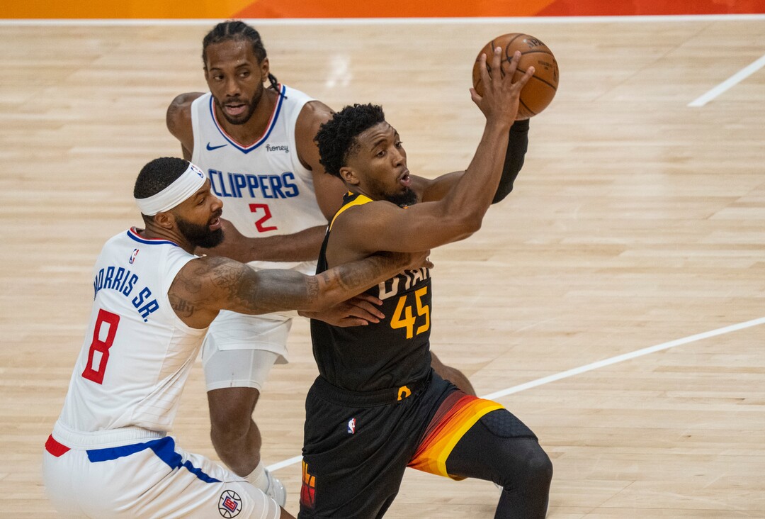 (Rick Egan | The Salt Lake Tribune) Donovan Mitchell (45) splits the LA defenders, forward Kawhi Leonard (2)] and Clippers forward Marcus Morris Sr. (8) to score for the Jazz, in NBA action between the Utah Jazz and the LA Clippers, in game one in the second round of the NBA playoff series at Vivint Arena, on Tuesday, June 8, 2021.
