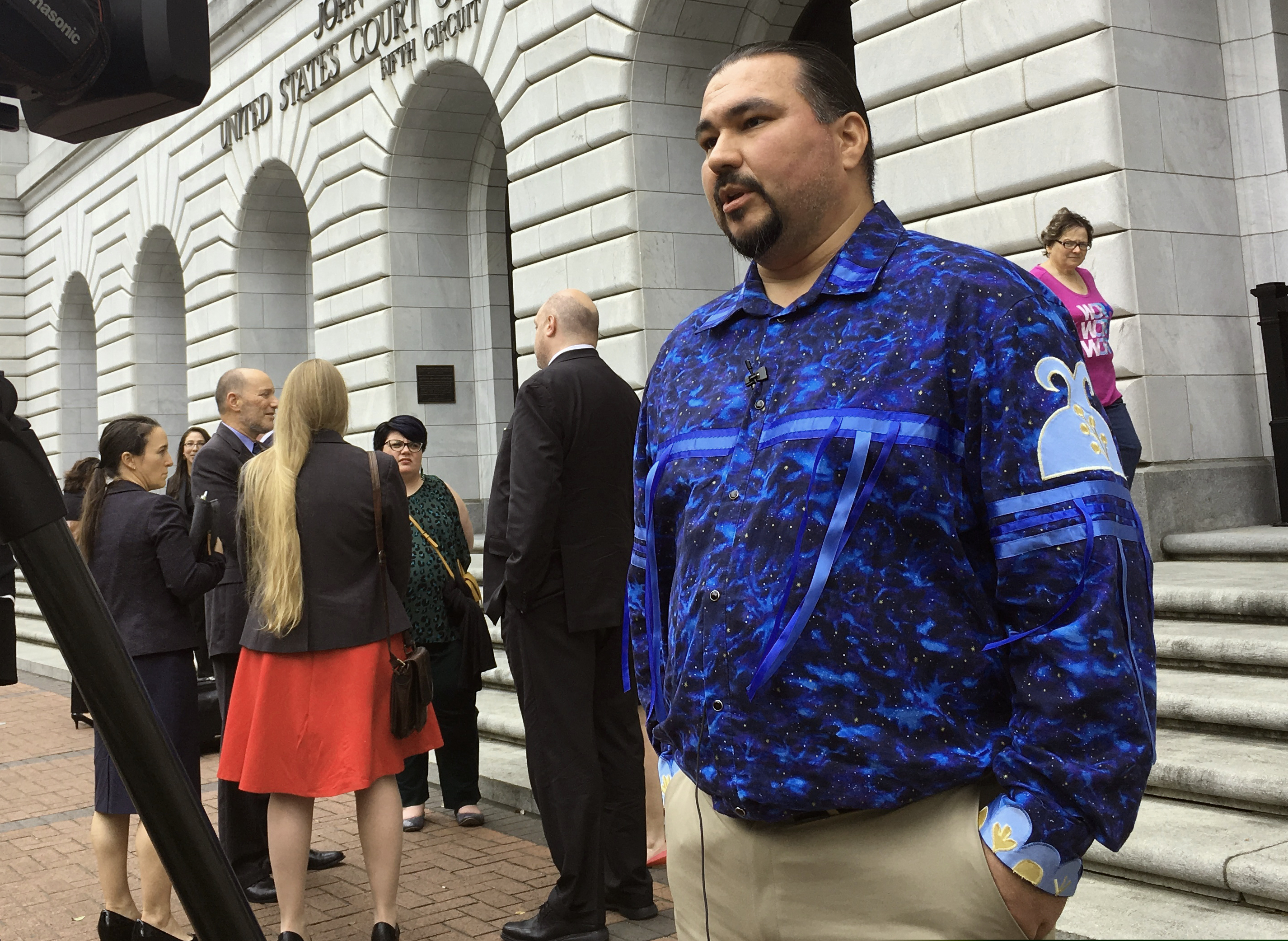 (Kevin McGill | AP file photo) Tehassi Hill, tribal chairman of the Oneida Nation, stands outside a federal appeals court in New Orleans, after arguments on the constitutionality of a 1978 law giving Native American families preference in adoption of Native American children on March 13, 2019. A federal appeals court says it will take a second look at an emotionally fraught lawsuit governing the adoption of Native American children. In August, a three-judge panel of the 5th U.S. Circuit Court of Appeals upheld the Indian Child Welfare Act of 1978. On Thursday, Nov. 7 the New Orleans-based court said a majority of its active judges have voted to re-hear the case.