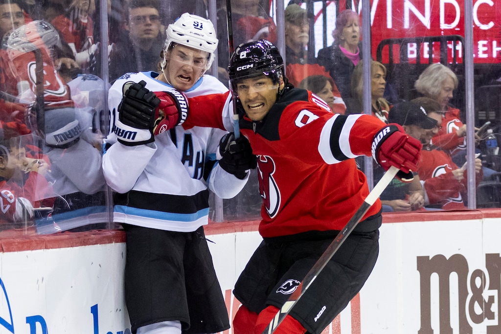 (Corey Sipkin | AP). New Jersey Devils defenseman Johnathan Kovacevic (8) checks Utah Hockey Club right wing Josh Doan (91) during the third period of an NHL hockey game, Monday, Oct. 14, 2024, in Newark, N.J.