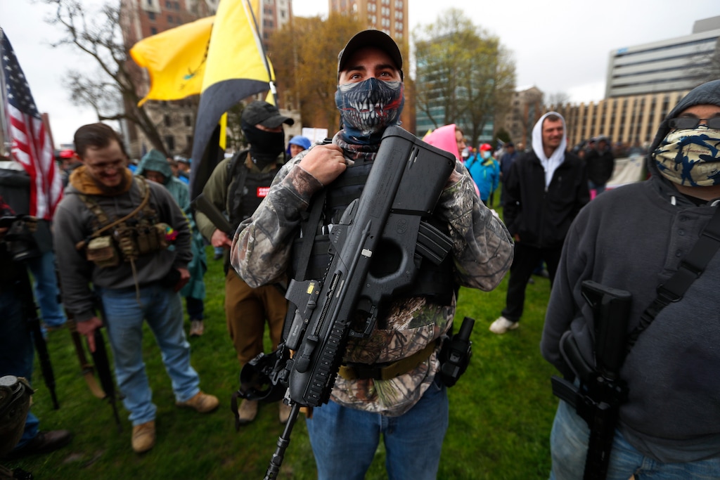 (Paul Sancya | AP photo)
In this April 30 photo, a protester carries his rifle at the State Capitol in Lansing, Mich. A plot to kidnap Michigan’s governor has put a focus on the security of governors who have faced protests and threats over their handling of the coronavirus pandemic. The threats have come from people who oppose business closures and restrictions on social gatherings.
