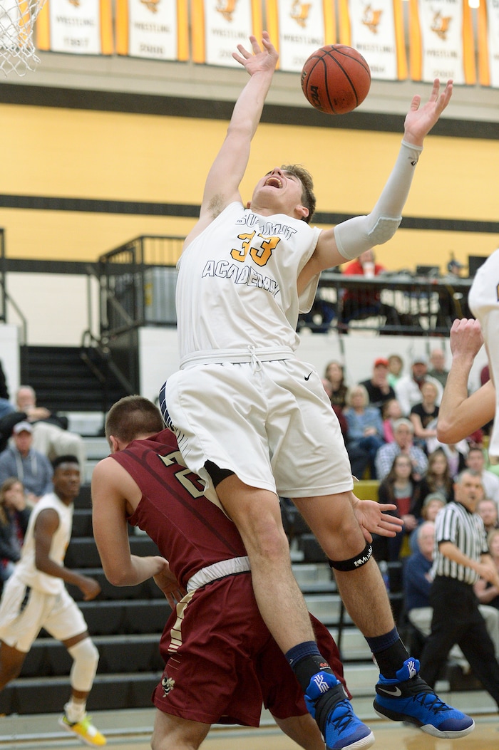 (Leah Hogsten  |  The Salt Lake Tribune) Summit's Tyler Kartchner goes over the back of Juab's Easton Wright to grab the rebound. Juab High School boys' basketball team defeated Summit Academy 61-58 during their 3A State tournament game in Heber  Saturday, Feb. 16, 2018.