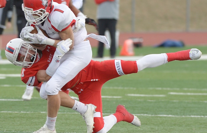 (Leah Hogsten  |  The Salt Lake Tribune) East's Chase Peterson takes down American Fork's Tyler Traveller. American Fork High School boys' football team East High School during their class 6A state quarterfinal football game, Friday, November 3, 2017