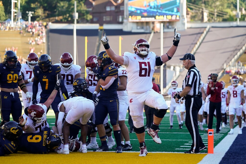 (Godofredo A. Vásquez | AP) Washington State offensive lineman Christian Hilborn (61) reacts after tight end Cooper Mathers scored a touchdown against California on Saturday, Nov. 11, 2023, in Berkeley, Calif.