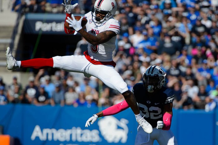 (Trent Nelson | The Salt Lake Tribune)  
Northern Illinois Huskies wide receiver Jauan Wesley (9) leaps for a reception ahead of Brigham Young Cougars defensive back Chris Wilcox (32) as BYU hosts Northern Illinois, NCAA football in Provo, Saturday Oct. 27, 2018.