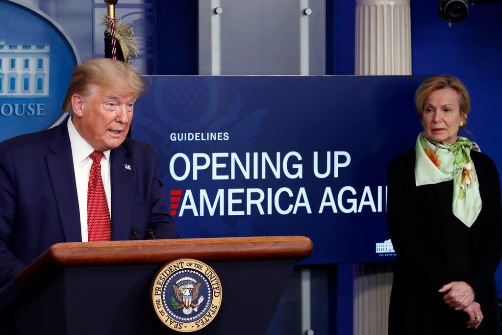 FILE - In this April 16, 2020, file photo, President Donald Trump speaks about the coronavirus in the James Brady Press Briefing Room of the White House in Washington, as Dr. Deborah Birx, White House coronavirus response coordinator, listens. The Trump administration has shelved a set of detailed documents created by the nation’s top disease investigators meant to give step-by-step advice to local leaders deciding when and how to reopen mass transit, day care centers, restaurants, bars and other public places during the still-raging pandemic. (AP Photo/Alex Brandon, File)