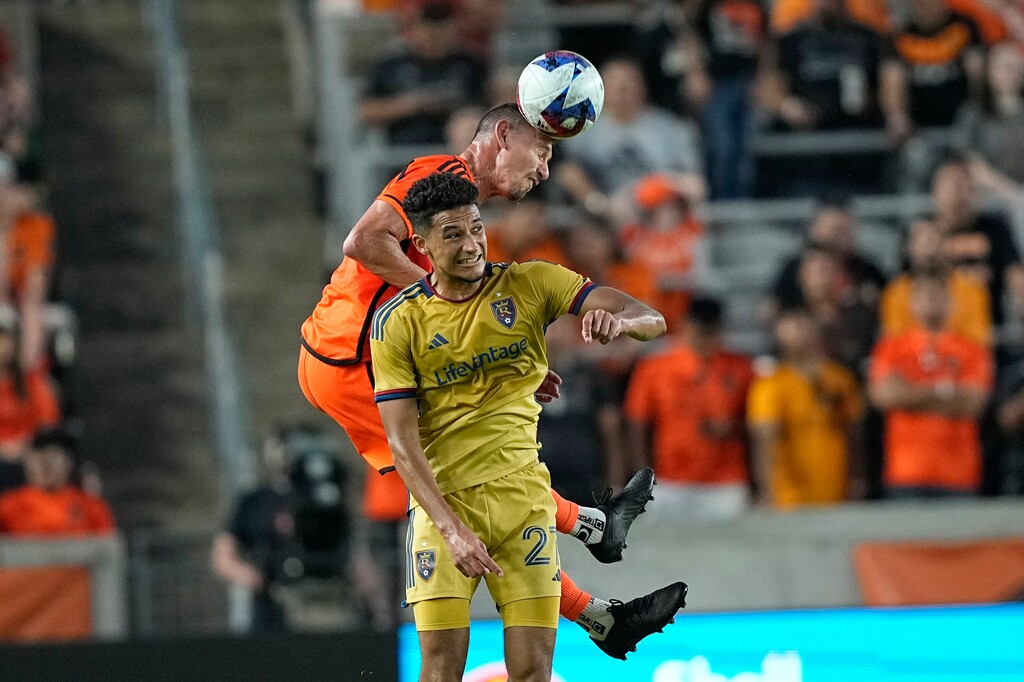 Houston Dynamo's Daniel Steres, rear, heads the ball over Real Salt Lake's Bertin Jacquesson (27) during the first half of an MLS soccer match Saturday, May 6, 2023, in Houston. (AP Photo/David J. Phillip)