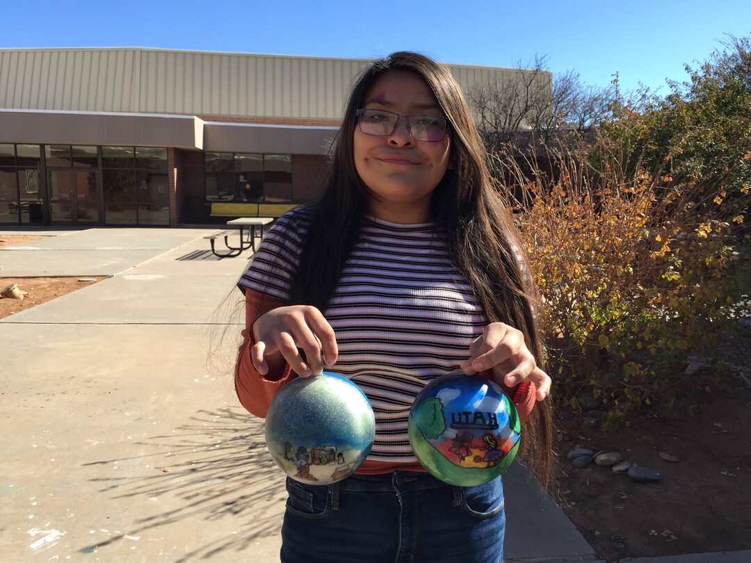 (Photo courtesy of Georgiana Simpson) A student at Whitehorse High School holds an ornament she painted.