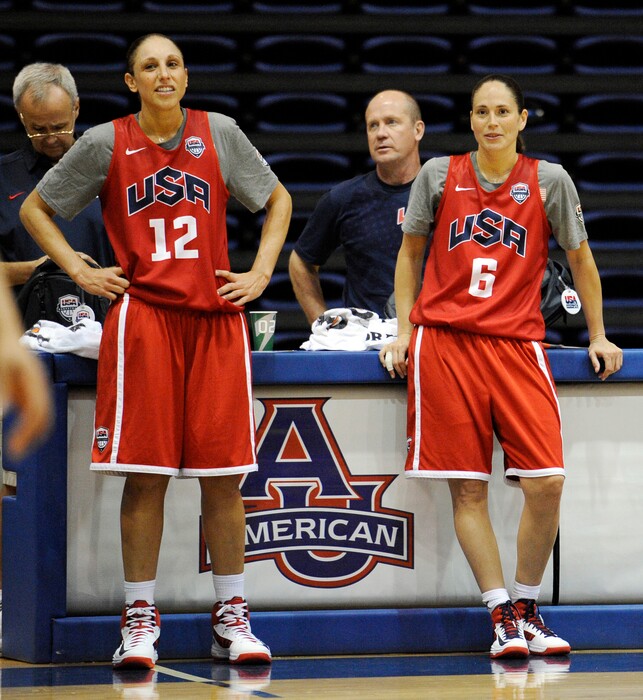 U.S women's Olympic basketball players Diana Taurasi (12) and Sue Bird (6) watch during practice in Washington. For nearly a decade the duo was playing over 100 games a year around the world and barely getting any time off to rest and recover. Besides making the lifestyle changes, the USA Basketball mainstays are now just playing in the WNBA, not putting the additional wear-and-tear on their bodies. Both players credit the changes off the court for the success on the court. (AP Photo/Nick Wass, File)