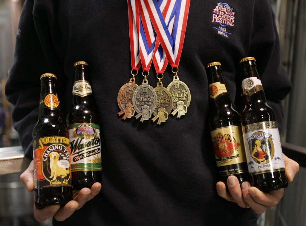 Wasatch Brewery brewmaster Dan Burick with the four medals (two golds, one silver and one bronze) his brews won at this year's Great American Beer Festival. Provo Girl Pilsner and India Pale Ale won gold medals, Chasing Tail Ale won silver and Wasatch Hefe Weisen won bronze.
Photo by Trent Nelson; 10.06.2004