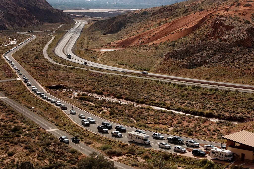(Leah Hogsten | The Salt Lake Tribune) A long line of vehicles queue up to enter Arches National Park in 2013. Advocates and city officials worry about traffic jams and other issues with the reservation system taken away.