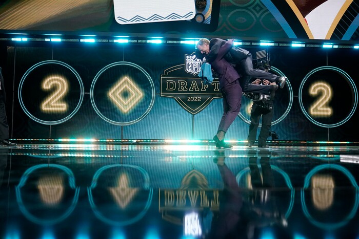 Utah linebacker Devin Lloyd lifts NFL Commissioner Roger Goodell after being chosen by the Jacksonville Jaguars with the 27th pick of the NFL football draft Thursday, April 28, 2022, in Las Vegas. (AP Photo/Jae C. Hong)