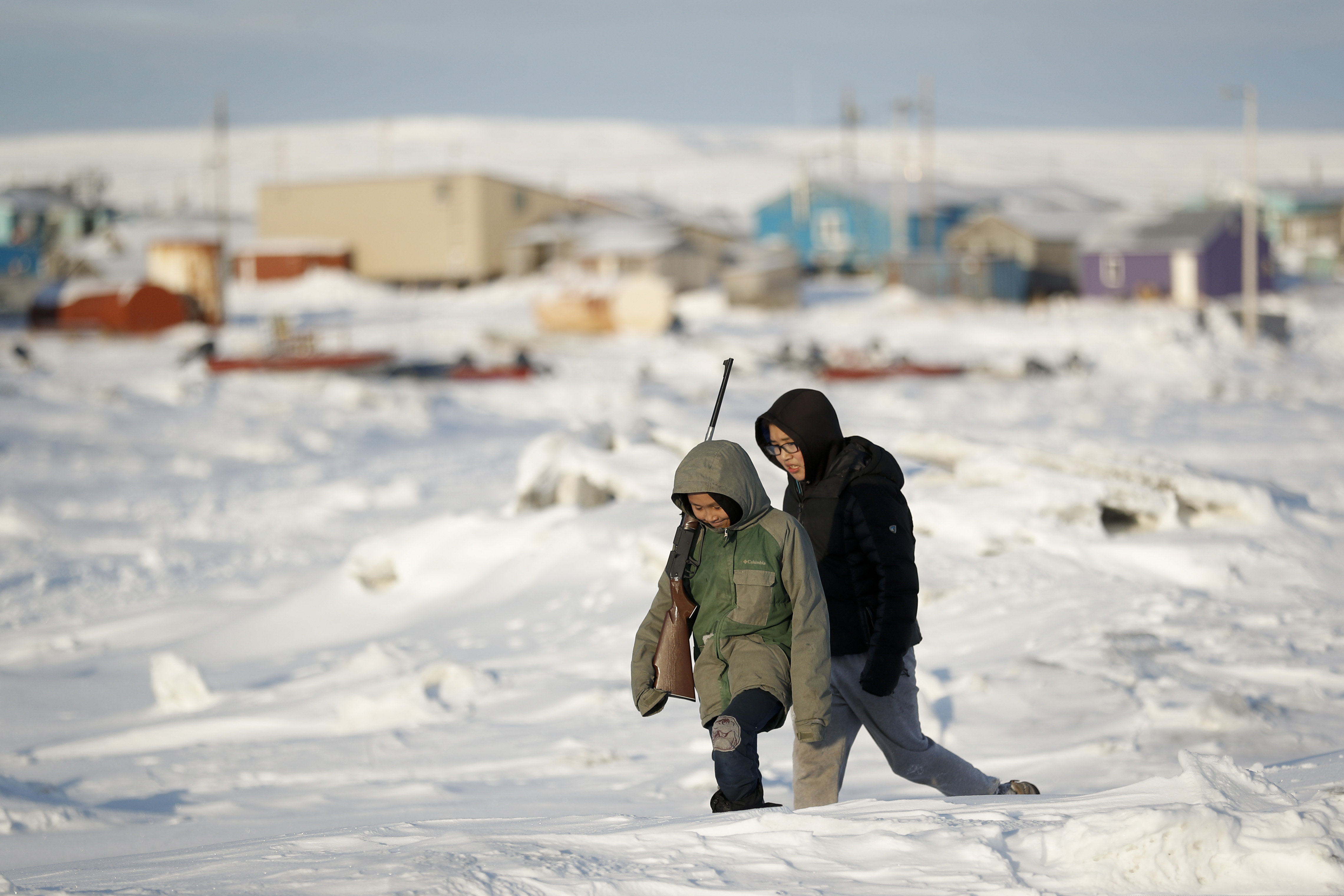 (Gregory Bull | AP) In this Jan. 18, 2020 photo, George Chakuchin, left, and Mick Chakuchin walk on ice over the Bering Sea in Toksook Bay, Alaska, a mostly Yuip'ik village. Native American leaders are raising questions about how $8 billion in federal coronavirus relief tagged for tribes will be distributed, with some arguing that for-profit Alaska Native corporations shouldn't get a share of the funding.
