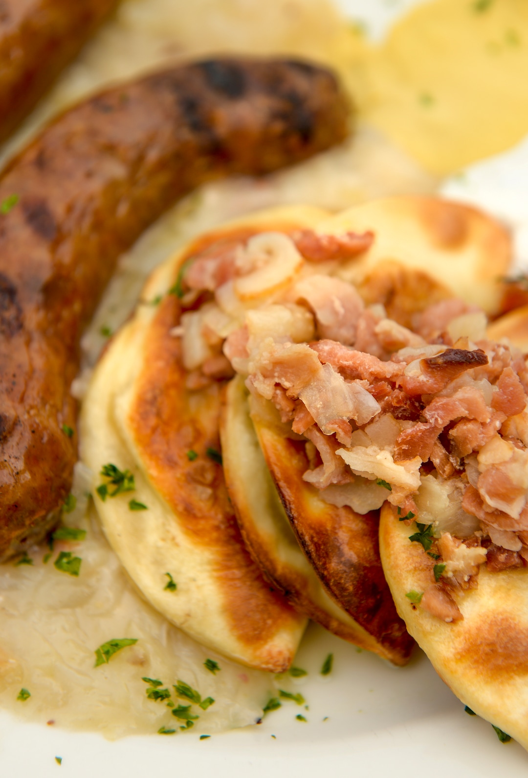 Leah Hogsten  |  The Salt Lake Tribune  Bohemian Brewery's pirogues and bratwurst -  pastry pockets filled with cheese, dill seasoned potatoes, served with bratwurst and sauerkraut topped with bacon, onions and dill sour cream, July 22, 2018. Midvale's Bohemian Brewery, famous for its European-style lagers as well as bratwurst, pierogies and goulash, has been bought. Bohemian Brewery's new owners are the same folks who own Porcupine Pub and Grille, the Dodo and The Rio Grand Cafe. While the new owners don't plan to change the restaurant or the Czech beers, they do hope to expand the brewery in the future.  