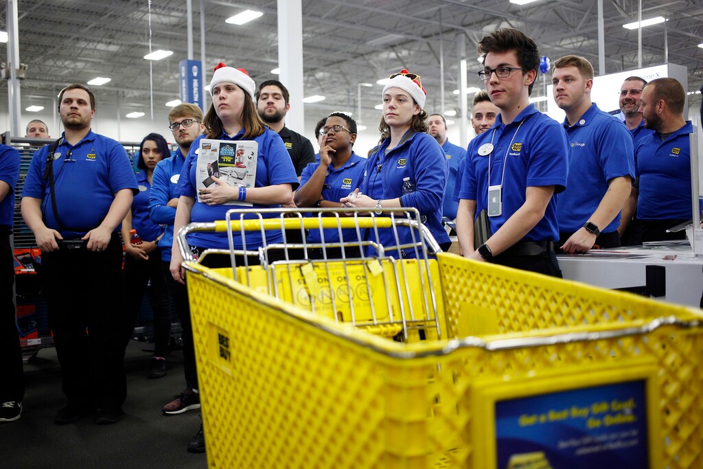Employees gather for a meeting before opening the doors at a Best Buy store in Louisville, Kentucky, on Nov. 23, 2017. (Luke Sharrett/Bloomberg)