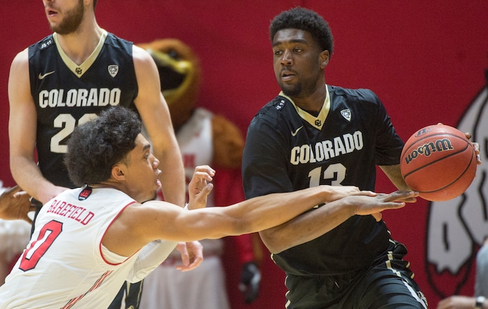 (Rick Egan  |  The Salt Lake Tribune) Colorado Buffaloes guard Namon Wright (13) brings the ball down court, as Utah Utes guard Sedrick Barefield (0) defends, in PAC-12 basketball action between Utah Utes and Colorado Buffaloes, at the Jon M. Huntsman Center, Saturday, March 3, 2018.