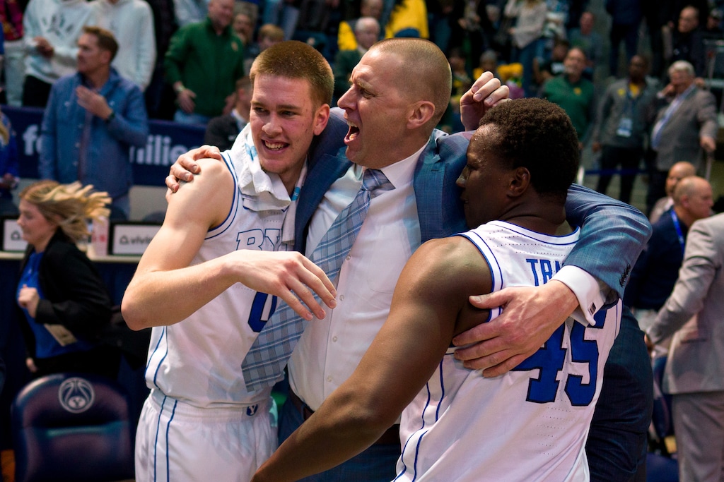 (Trent Nelson | The Salt Lake Tribune) Brigham Young Cougars forward Noah Waterman (0), Mark Pope, and Brigham Young Cougars forward Fousseyni Traore (45) celebrate the win as BYU hosts Baylor, NCAA basketball in Provo on Tuesday, Feb. 20, 2024.