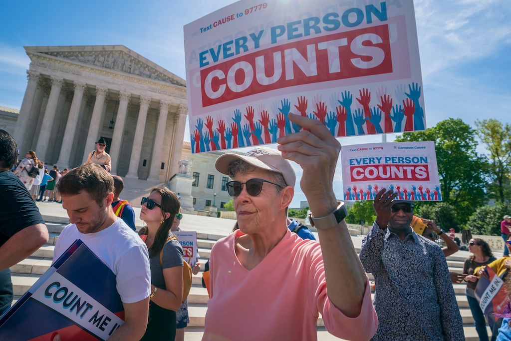 FILE - In this April 23, 2019 file photo, Immigration activists rally outside the Supreme Court as the justices hear arguments over the Trump administration's plan to ask about citizenship on the 2020 census, in Washington. Voting rights activists argue that newly discovered 2015 correspondence between a GOP redistricting expert and a current Census Bureau official bolster arguments that discrimination motivated efforts to add a citizenship question to the 2020 population survey. The plaintiffs, who successfully challenged the question in a Maryland federal court, said in a filing late Friday, June 14 that the email exchange between the late Republican consultant Thomas Hofeller and the Census Bureau official was discovered earlier this week. (AP Photo/J. Scott Applewhite)