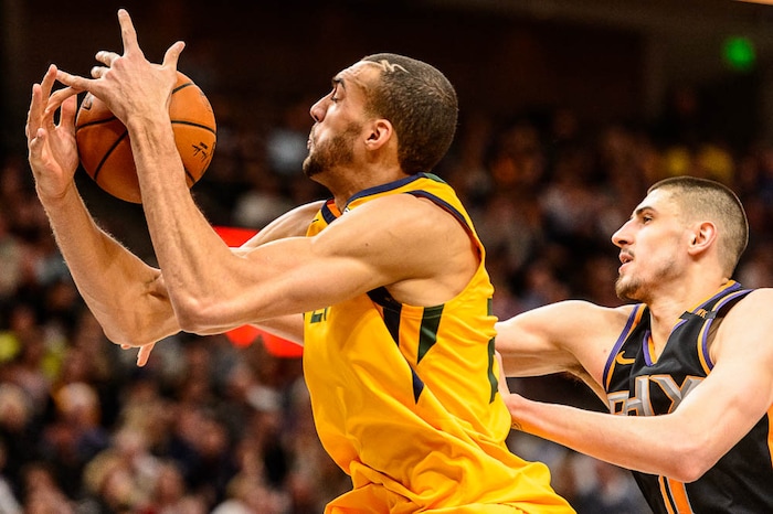 (Trent Nelson | The Salt Lake Tribune)  Utah Jazz center Rudy Gobert (27) pulls in a rebound as the Utah Jazz host the Phoenix Suns, NBA basketball in Salt Lake City, Wednesday Feb. 14, 2018. Phoenix Suns center Alex Len (21) at right.