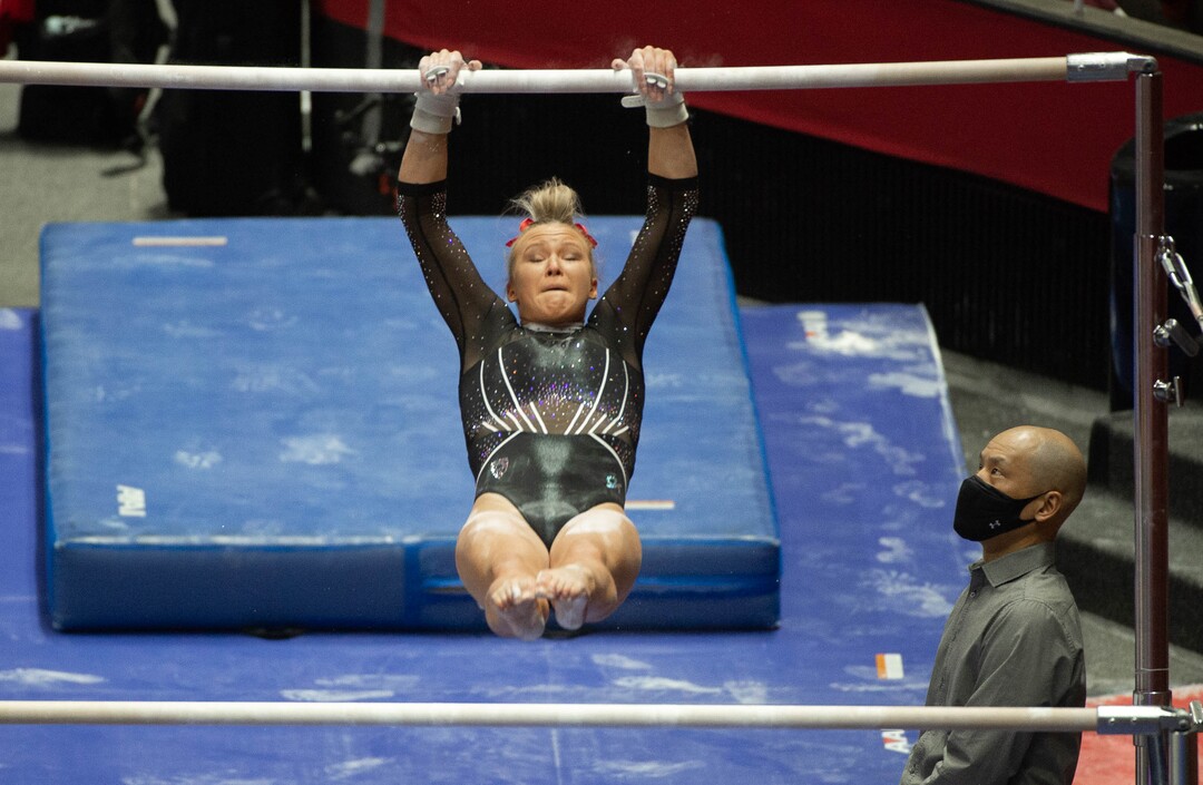(Francisco Kjolseth  | The Salt Lake Tribune) Abby Paulson competes on the uneven bars alongside head coach Tom Farden in PAC-12 gymnastics action Utah vs UCLA, at the Huntsman Center on Friday, Feb. 19, 2021.