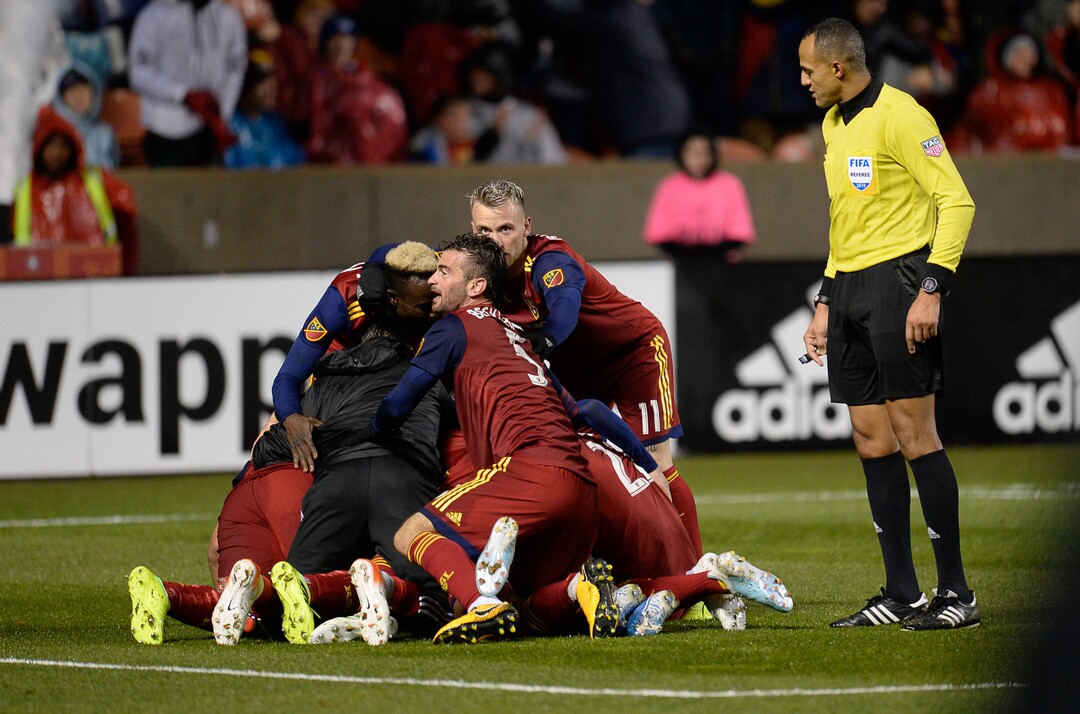 (Francisco Kjolseth  |  The Salt Lake Tribune)  Real Salt Lake forward Jefferson Savarino (7) gets piled on by his teammates after scoring the game winning goal 2-1, as Real Salt Lake and the Portland Timbers play in their first MLS playoff game at Rio Tinto Stadium in Sandy, Utah on Saturday, Oct. 19, 2019.