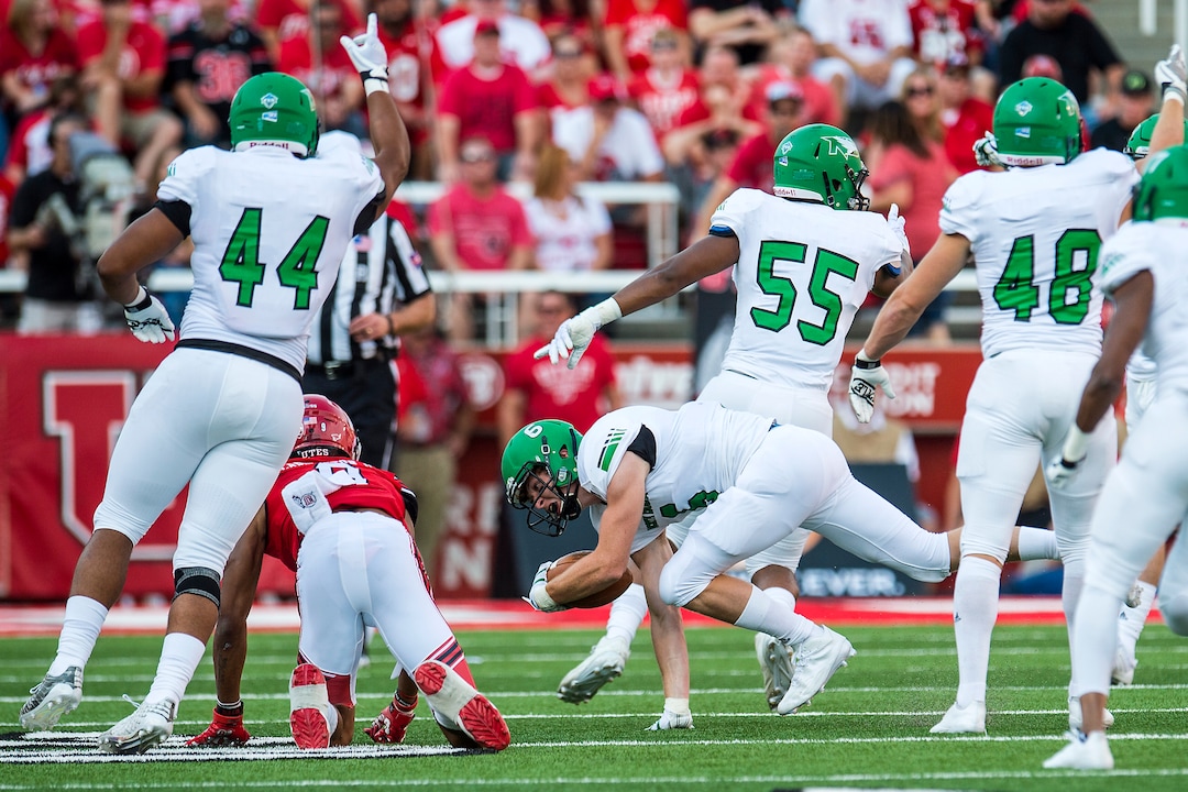 (Chris Detrick  |  The Salt Lake Tribune)  North Dakota Fighting Hawks defensive back Evan Holm (6) intercepts the ball intended for Utah Utes wide receiver Darren Carrington (9) during the game at Rice-Eccles Stadium Thursday, August 31, 2017. Utah Utes are leading North Dakota Fighting Hawks 17-9 at halftime. 