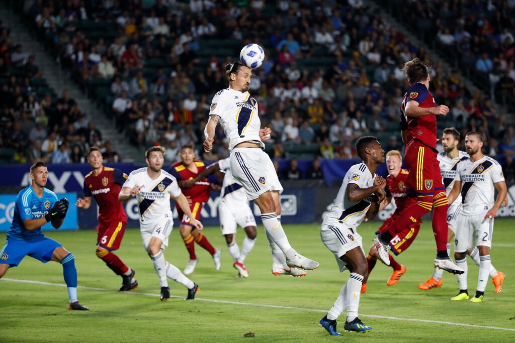 Los Angeles Galaxy's Zlatan Ibrahimovic, center, of Sweden, heads the ball during the first half of an MLS soccer match against the Real Salt Lake Saturday, June 9, 2018, in Carson, Calif. (AP Photo/Jae C. Hong)