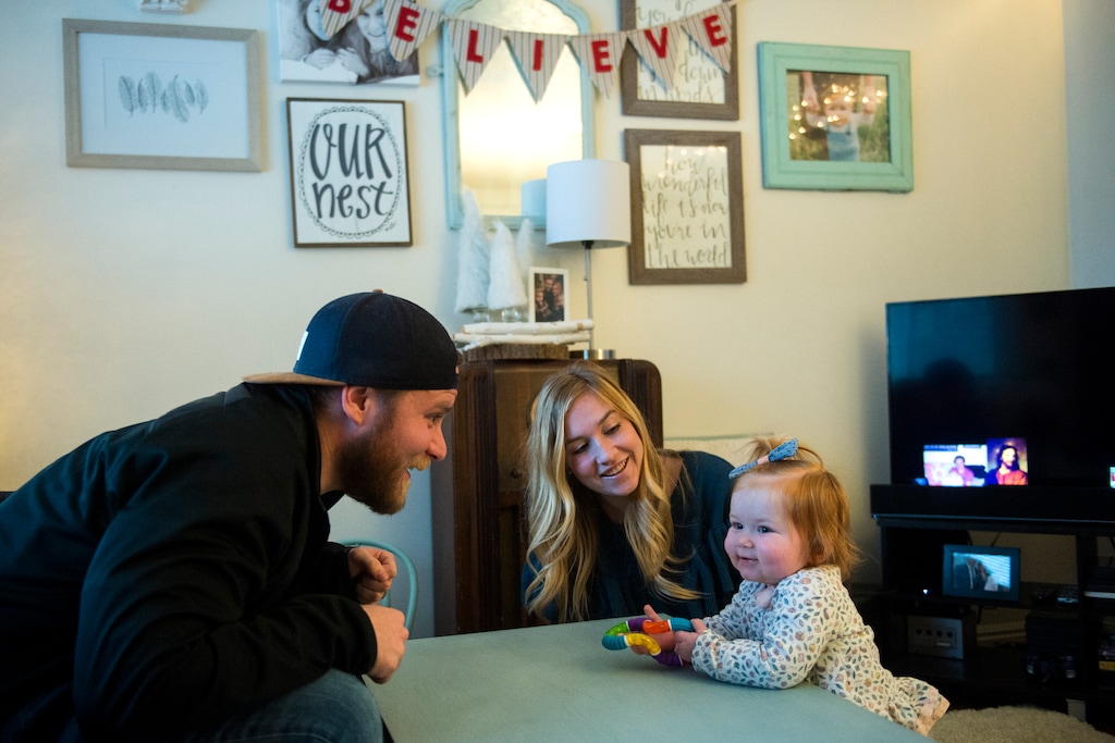 (Chris Detrick  |  The Salt Lake Tribune)  Jenna and David Burrahm play with their daughter Faye, 14 months, in their apartment in Salt Lake City Wednesday, December 20, 2017.  