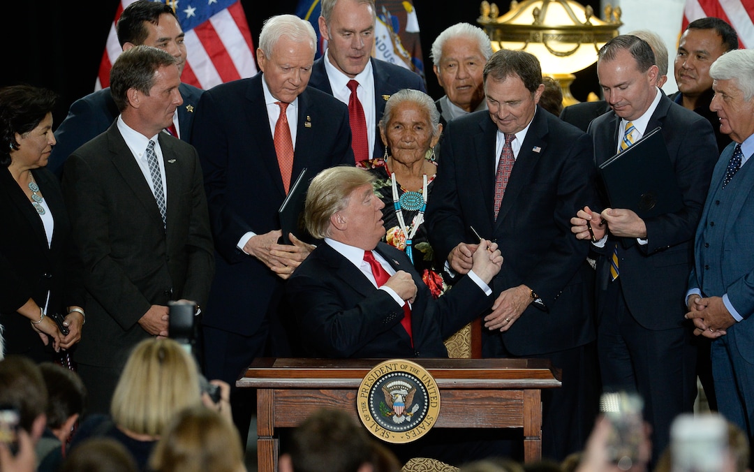 (Francisco Kjolseth  |  The Salt Lake Tribune)  U.S. President Donald Trump is surrounded by Utah representatives at the Utah Capitol on Monday, Dec. 4, 2017, gives Utah Gov. Gary Herbert one of the pens used to sign two presidential proclamations to shrink Bears Ears and Grand Staircase-Escalante national monuments.