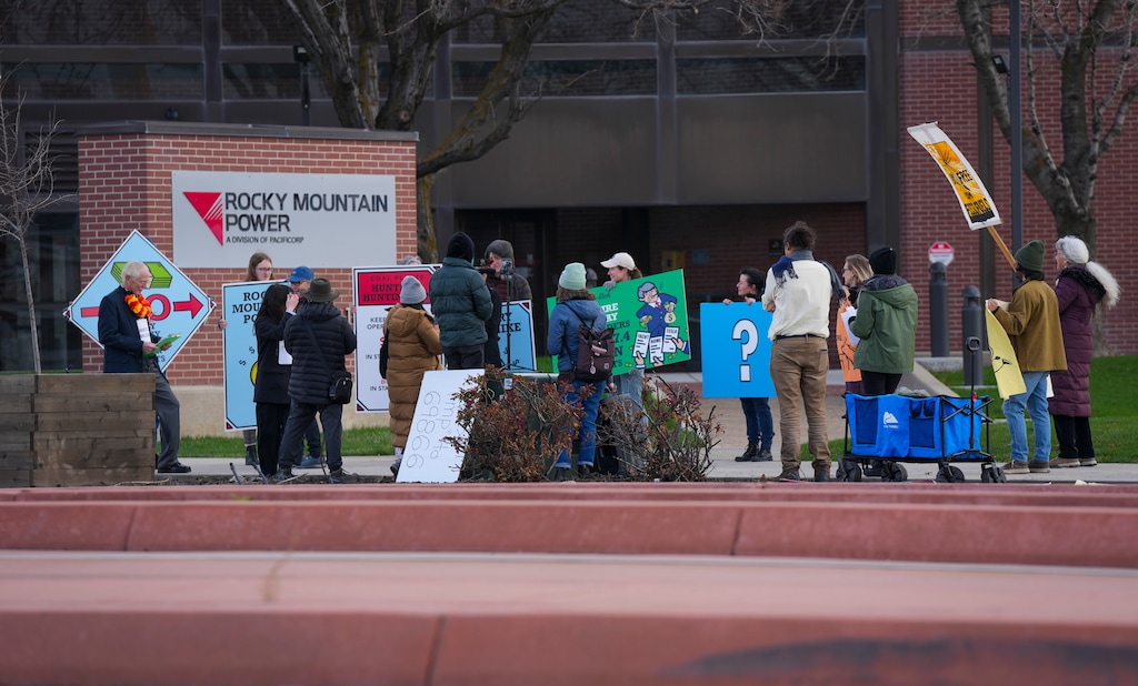 (Bethany Baker | The Salt Lake Tribune) Protesters gather during a Monopoly-themed rally to protest utility-driven rate hikes and obstacles to renewable energy at the corporate headquarters for Rocky Mountain Power in Salt Lake City on Tuesday, April 1, 2025.