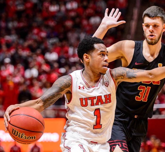 (Trent Nelson | The Salt Lake Tribune)  Utah Utes guard Justin Bibbins (1), USC Trojans forward Nick Rakocevic (31), as the University of Utah hosts USC, NCAA basketball at the Huntsman Center in Salt Lake City, Saturday Feb. 24, 2018.