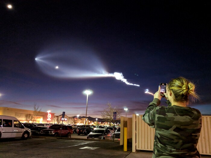 A Hair Salon worker photographs the light display of SpaceX's Falcon 9 rocket launch, Friday, Dec. 22 2017, in Apple Valley, Calif. The launch was more than 200 miles from Apple Valley yet was still brilliantly visible. The Falcon 9 booster lifted off from coastal Vandenberg Air Force Base, carrying the latest batch of satellites for Iridium Communications. (James Quigg/The Daily Press via AP)