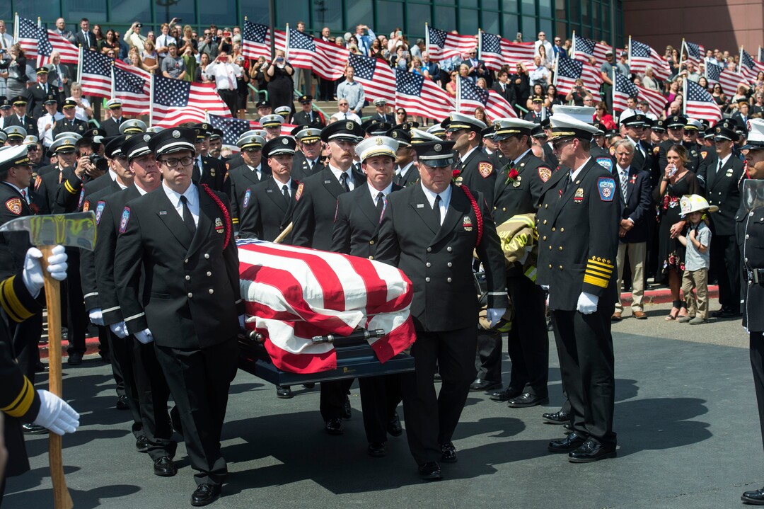 (Rick Egan  |  The Salt Lake Tribune)   The casket with fallen Utah firefighter Matthew Burchett is loaded into a fire engine after the funeral at the Maverick Center, Monday, Aug. 20, 2018.