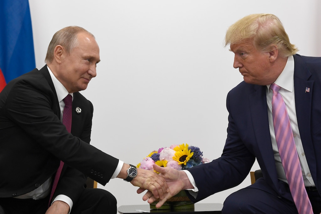 FILE - In this June 28, 2019, file photo President Donald Trump, right, shakes hands with Russian President Vladimir Putin, left, during a bilateral meeting on the sidelines of the G-20 summit in Osaka, Japan. (AP Photo/Susan Walsh, File)