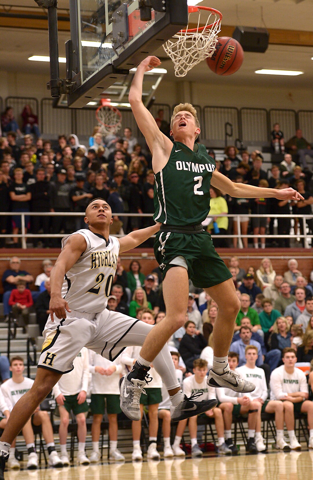(Leah Hogsten  |  The Salt Lake Tribune)  Highland's Elijah Shelton swats away Olympus' Jacob DowDell. Olympus High School defeated Highland High School 86-54 during their basketball game, Tuesday, February 6, 2018.