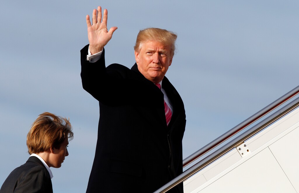 President Donald Trump waves as he boards Air Force One with his son Barron Trump, as they depart Tuesday, Nov. 21, 2017, at Andrews Air Force Base, Md. Trump is en route to his Mar-a-Largo resort in Florida for the Thanksgiving holiday. (AP Photo/Alex Brandon)