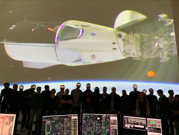 In this photo provided by SpaceX, the SpaceX team in Hawthorne, Calif., watches as the SpaceX Crew Dragon docks with the International Space Station’s Harmony module, Sunday, March 3, 2019. SpaceX's new crew capsule arrived at the International Space Station on Sunday, acing its second milestone in just over a day.  (NASA via AP)